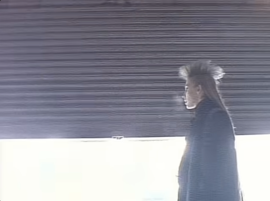 Woman with freaky hairstyle walking the streets at night in the 80s.