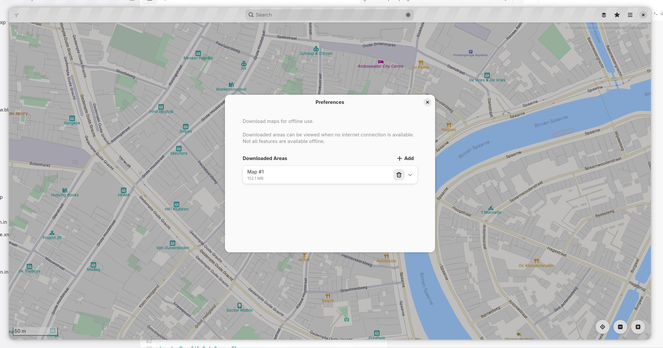GNOME Maps showing preference dialog with list of downloaded map areas and the option to download an additional area.