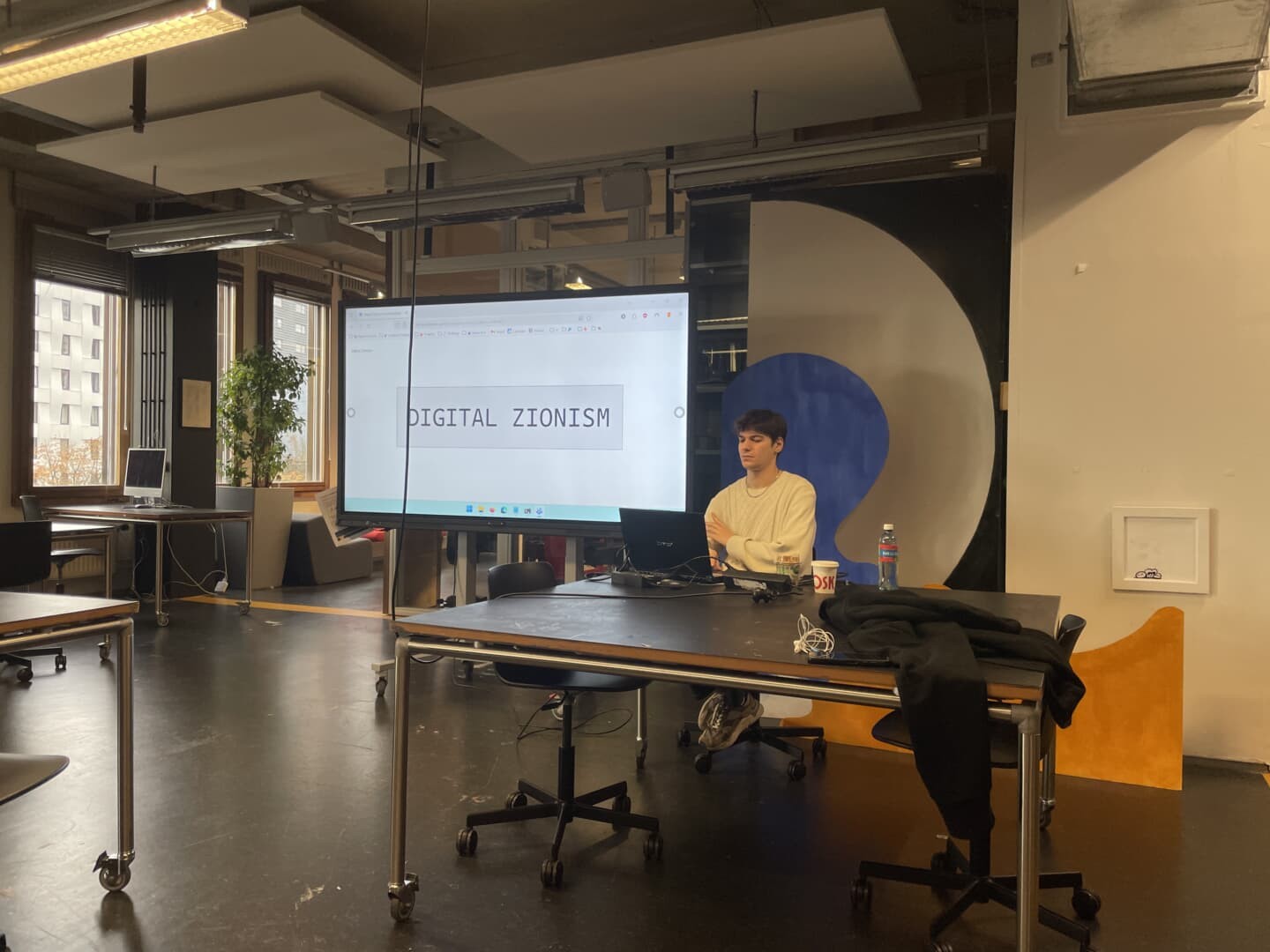 Leo talking and displaying a slide with the text “Digital Zionism”