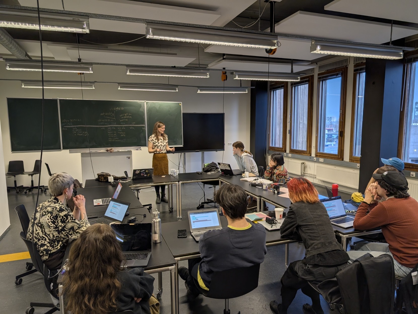 Sammy in the Acquarium with a group of people listening